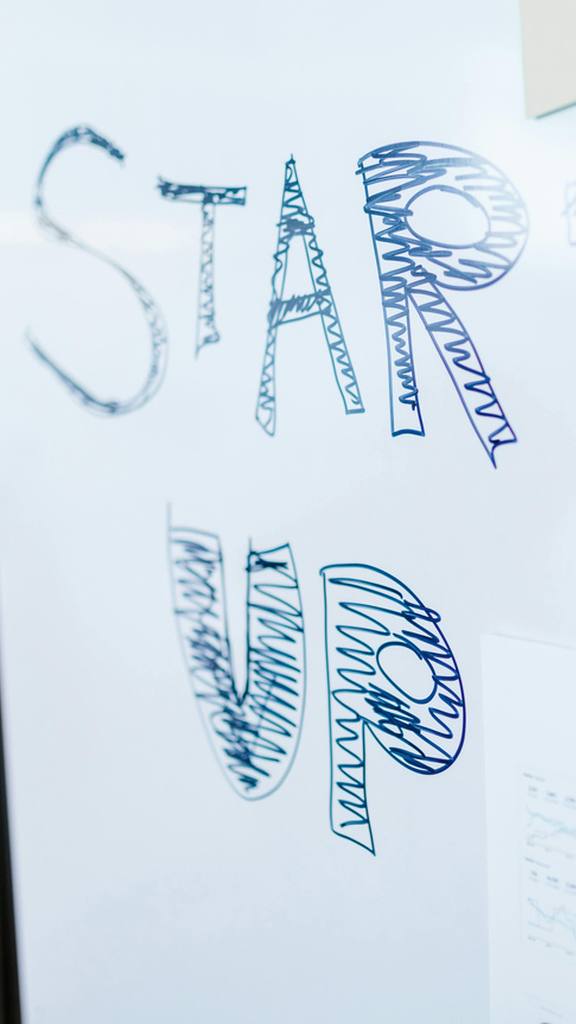 'Start up' handwritten on a whiteboard