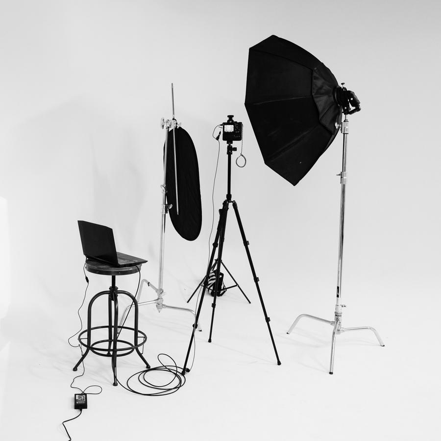 Studio lights, a laptop on a stool and a camera on a tripod